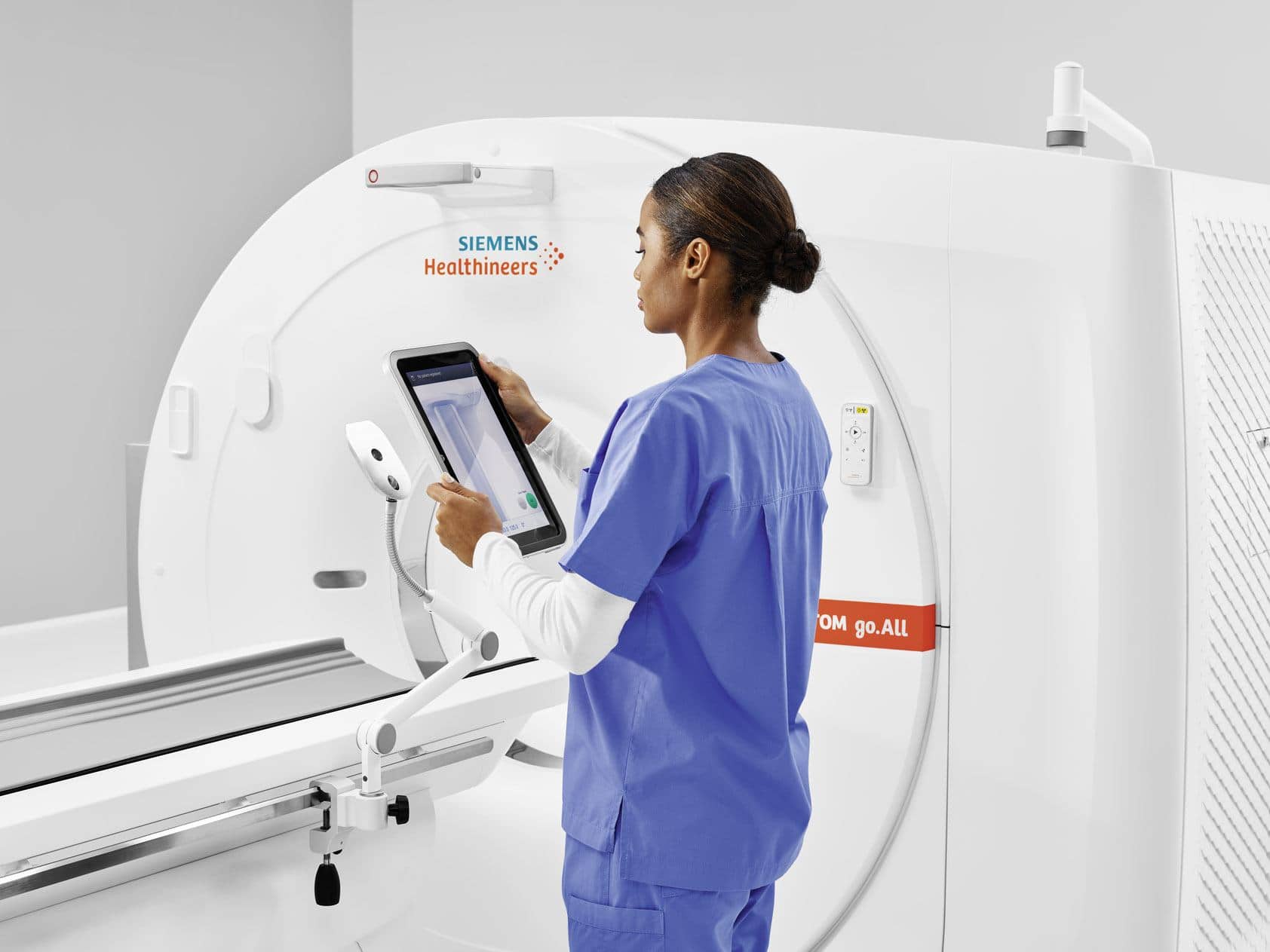 Nurse using touchscreen near Siemens CT Scanner machine