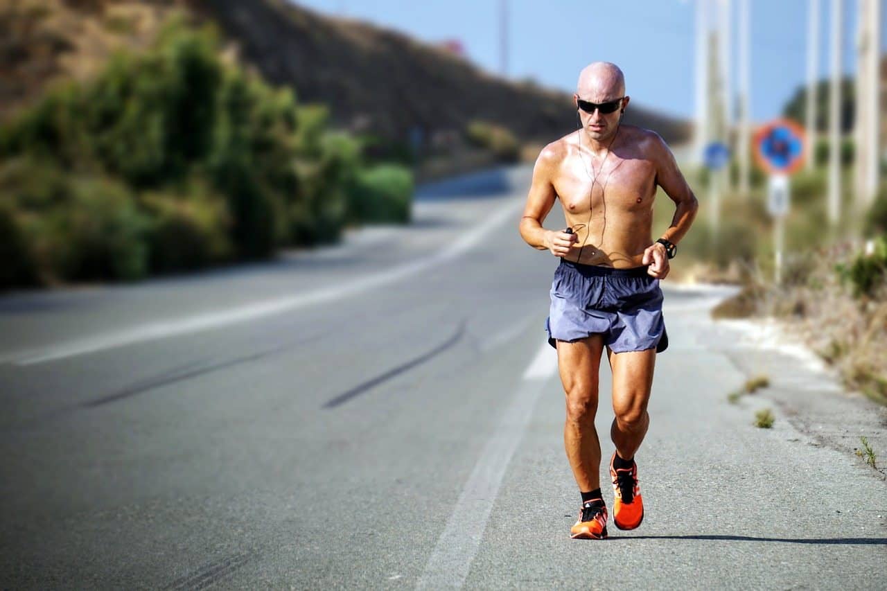 Man over 50 running along road exercising