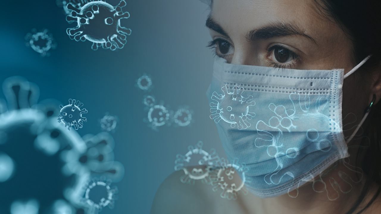 Woman wearing mask with illustrations of Coronavirus on image