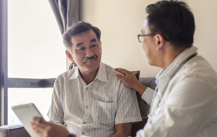doctor speaking to older male patient reassuringly
