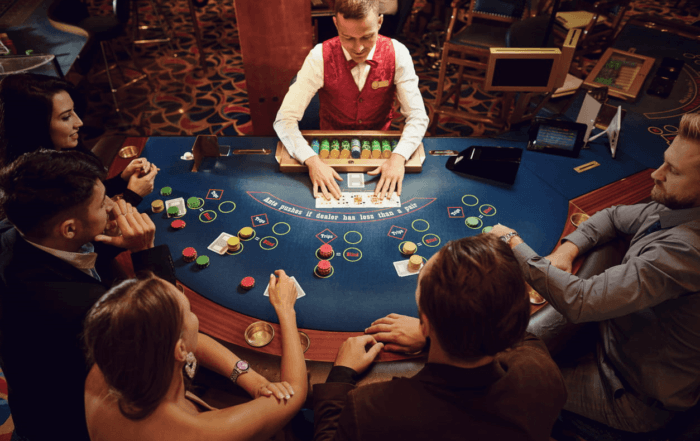 A casino worker dealing at a table who has to deal with higher cancer rates from secondhand smoke.