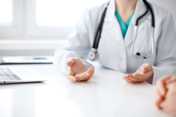 The focus is on a doctor discussing health screenings with their patient.