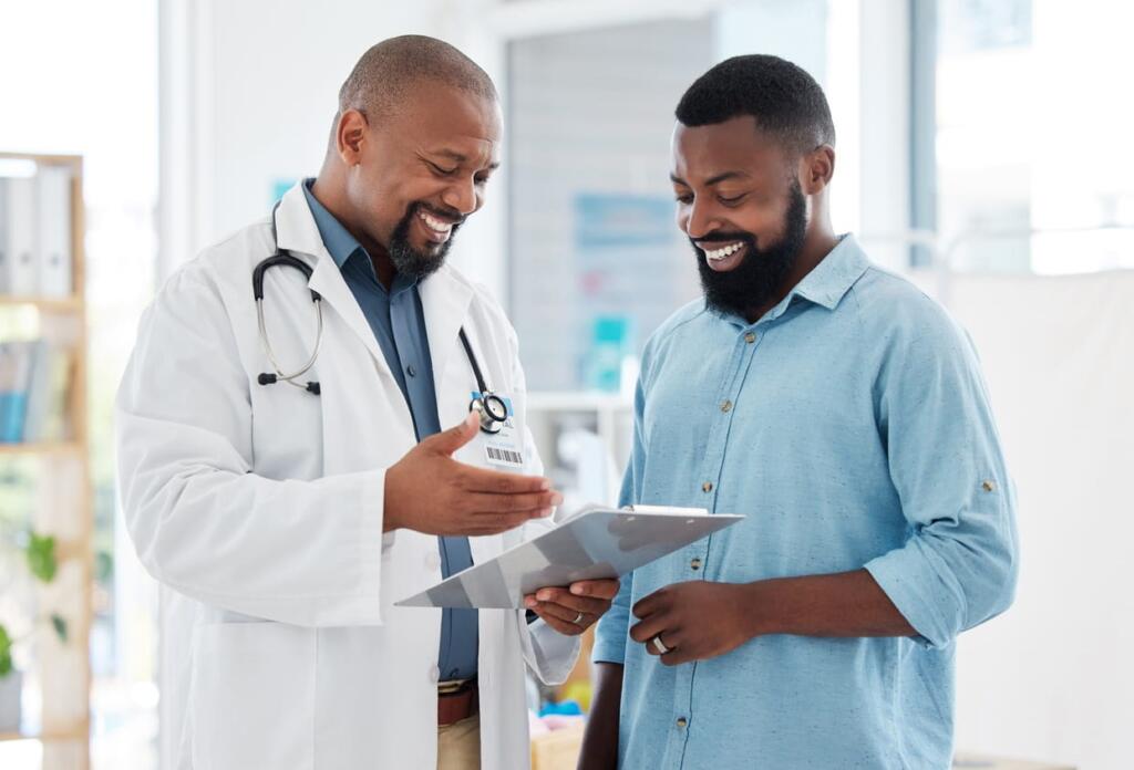 A doctor is going over a health screening with his patient.