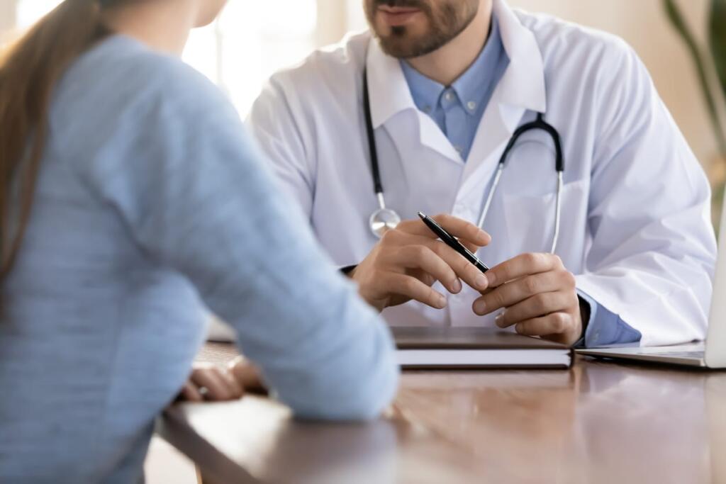 A doctor reviewing lifeguard cancer rates with their patient.