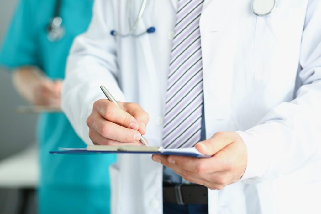 A doctor reviewing a patient's chart for preventative scans.