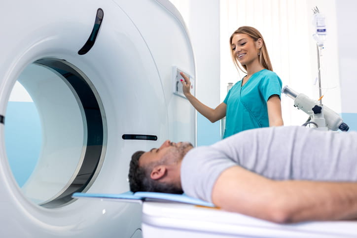 A nurse assisting a patient as he receives a low-dose CT scan. 