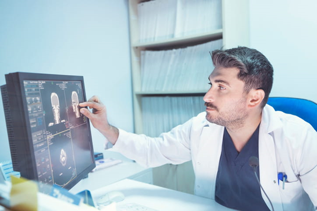 Doctor looking at results of scan on screen