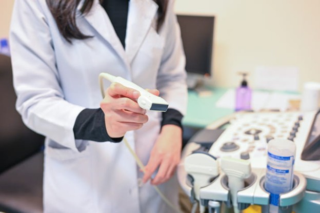 General Ultrasound Screening Bundle A Technician Holds The Wand Of An Ultrasound Machine.