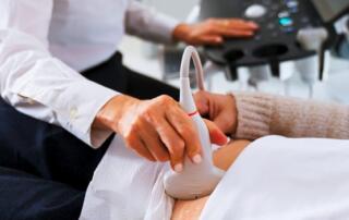 A Tech Is Performing An Abdominal Ultrasound On A Patient.